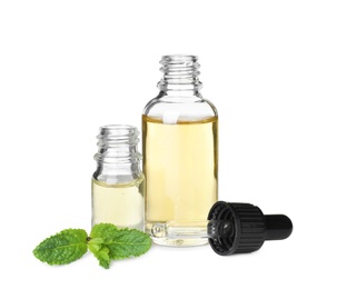 Different bottles of essential oils and mint on white background