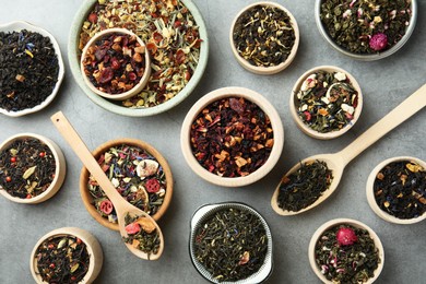 Photo of Many different herbal teas on grey table, flat lay