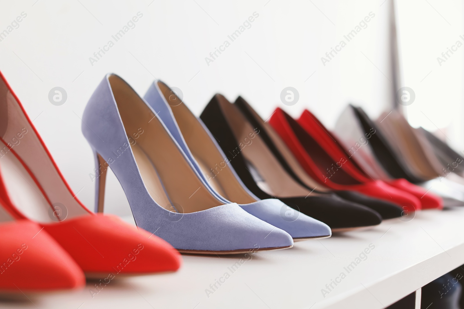 Photo of High heeled shoes on shelf in store