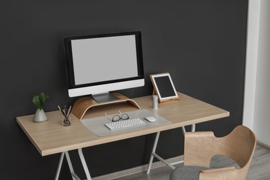 Modern workplace interior with computer on table. Space for text