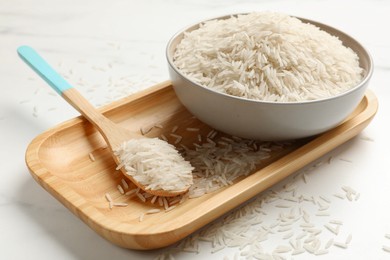 Photo of Uncooked raw basmati rice on white table