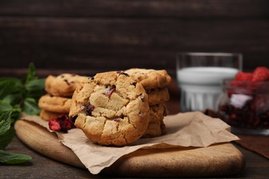 Photo of Cookies with freeze dried fruits and mint on wooden table, closeup