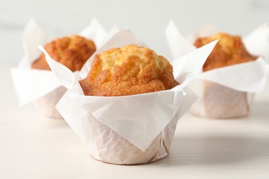 Tasty muffins on white wooden table, closeup. Fresh pastry