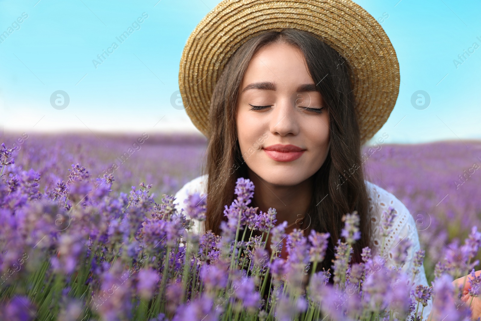 Photo of Young woman in lavender field on summer day