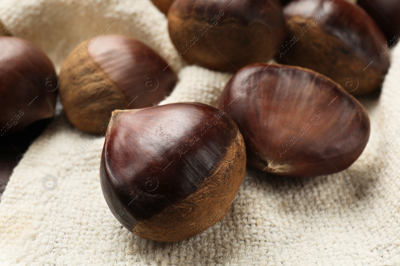 Photo of Sweet fresh edible chestnuts on table, closeup