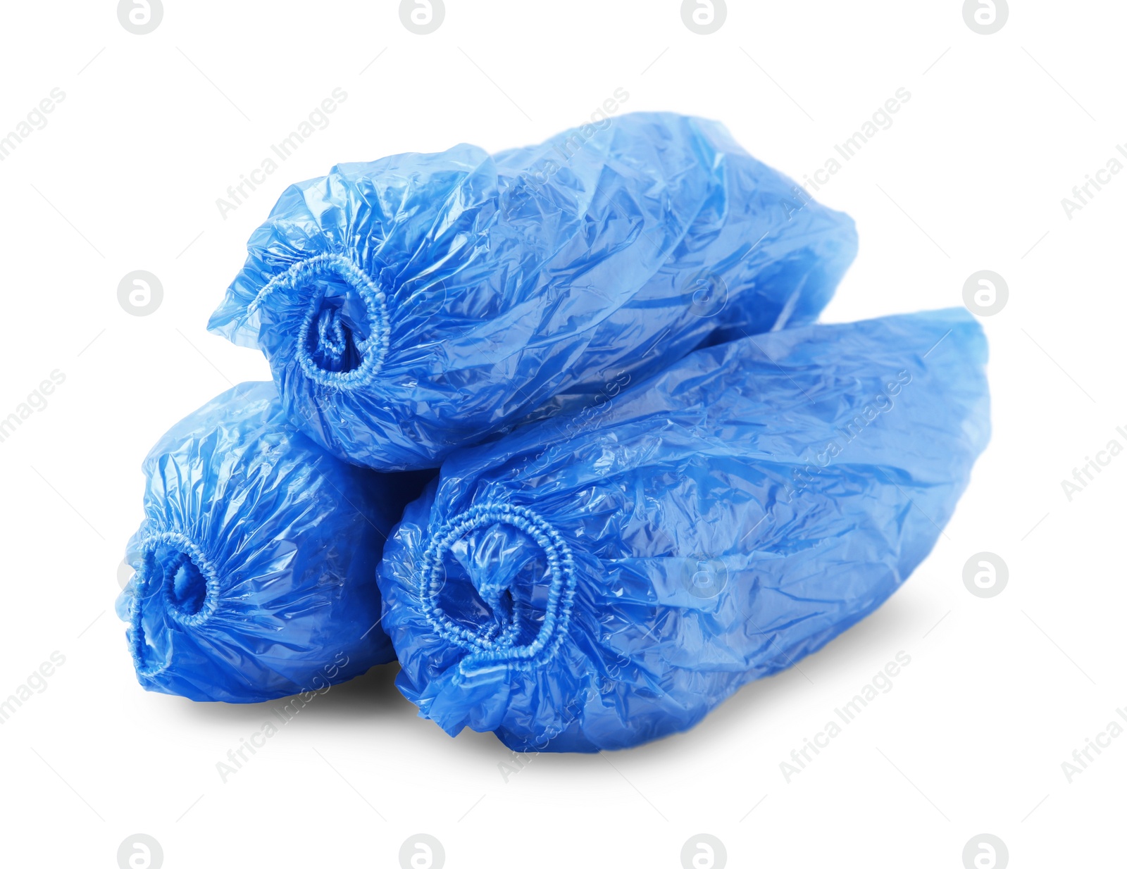 Photo of Rolled blue shoe covers isolated on white