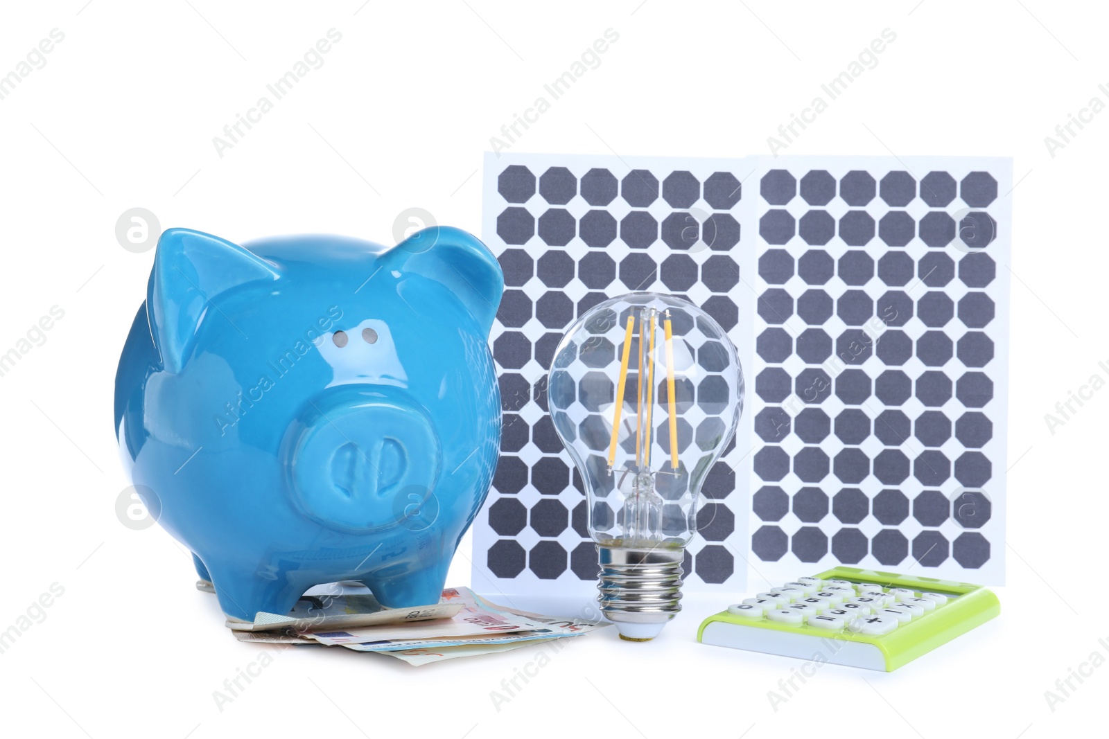 Photo of Composition with solar panels and piggy bank on white background