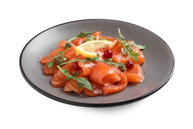 Photo of Salmon carpaccio with capers, cranberries, arugula and lemon isolated on white