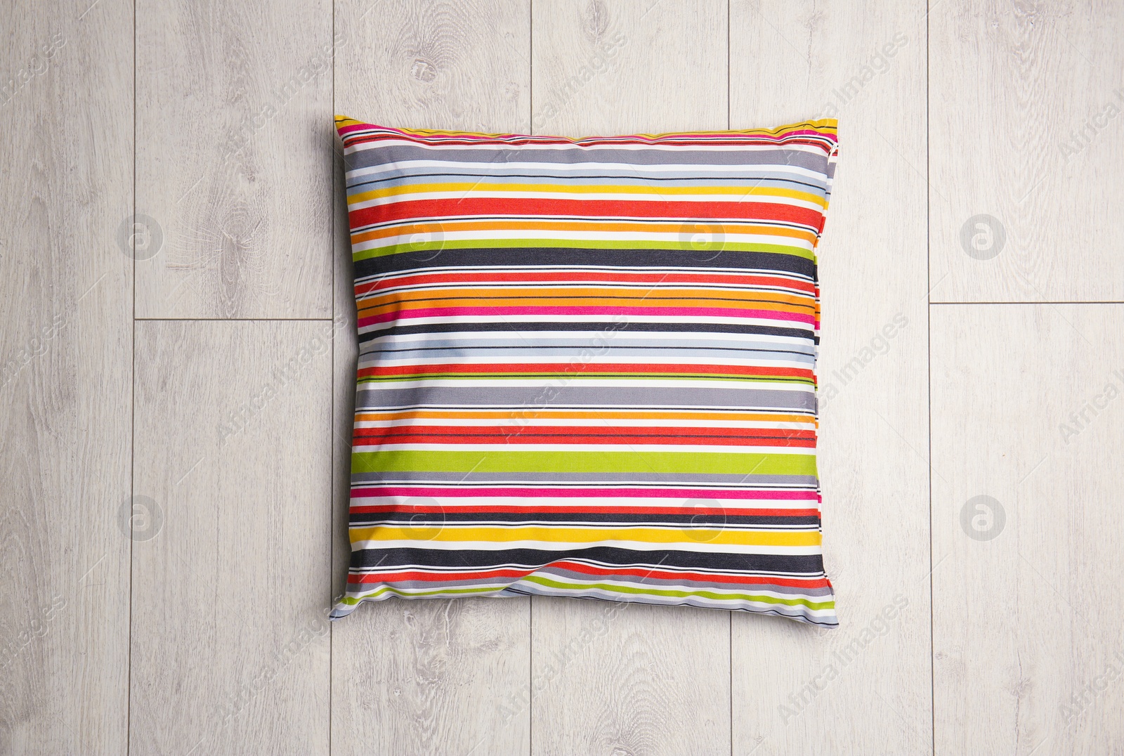 Photo of Soft decorative pillow on wooden background, top view