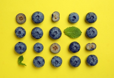 Flat lay composition with tasty blueberry on color background