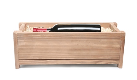 Photo of Open wooden crate with bottle of wine isolated on white