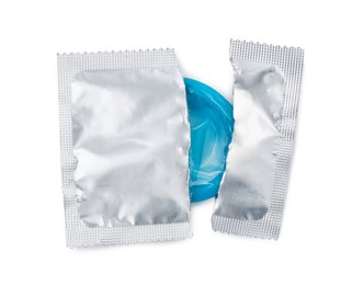 Condom in torn package on white background, top view. Safe sex