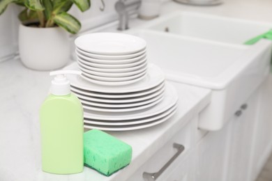 Clean dishes and cleaning product in stylish kitchen