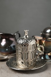 Photo of Vintage tea set on grey table, closeup. Space for text