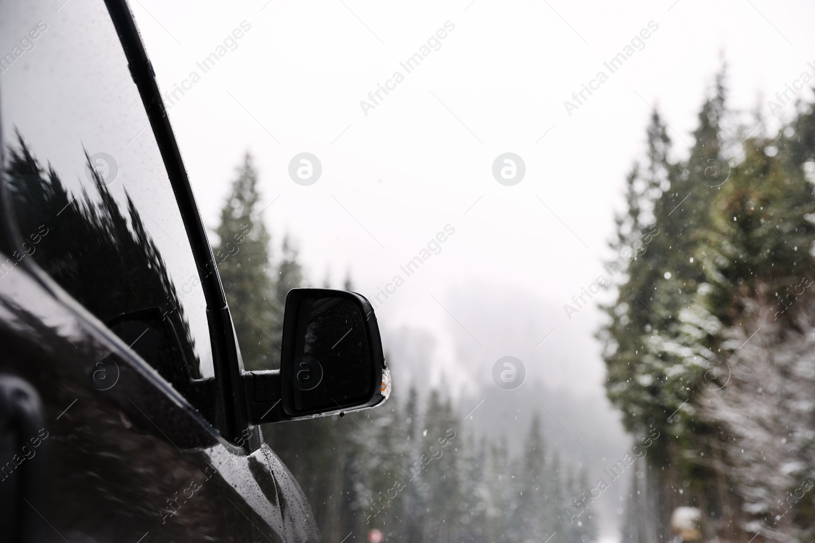 Photo of Car parked outdoors on snowy winter day