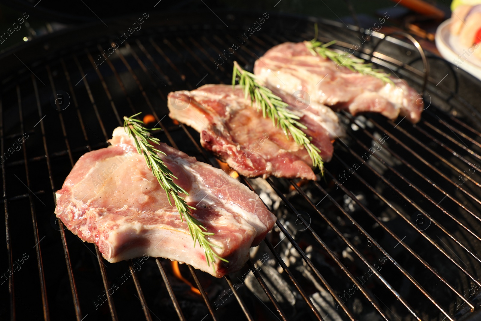 Photo of Cooking meat on barbecue grill outdoors, closeup