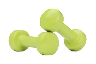 Photo of Light green dumbbells isolated on white. Sports equipment