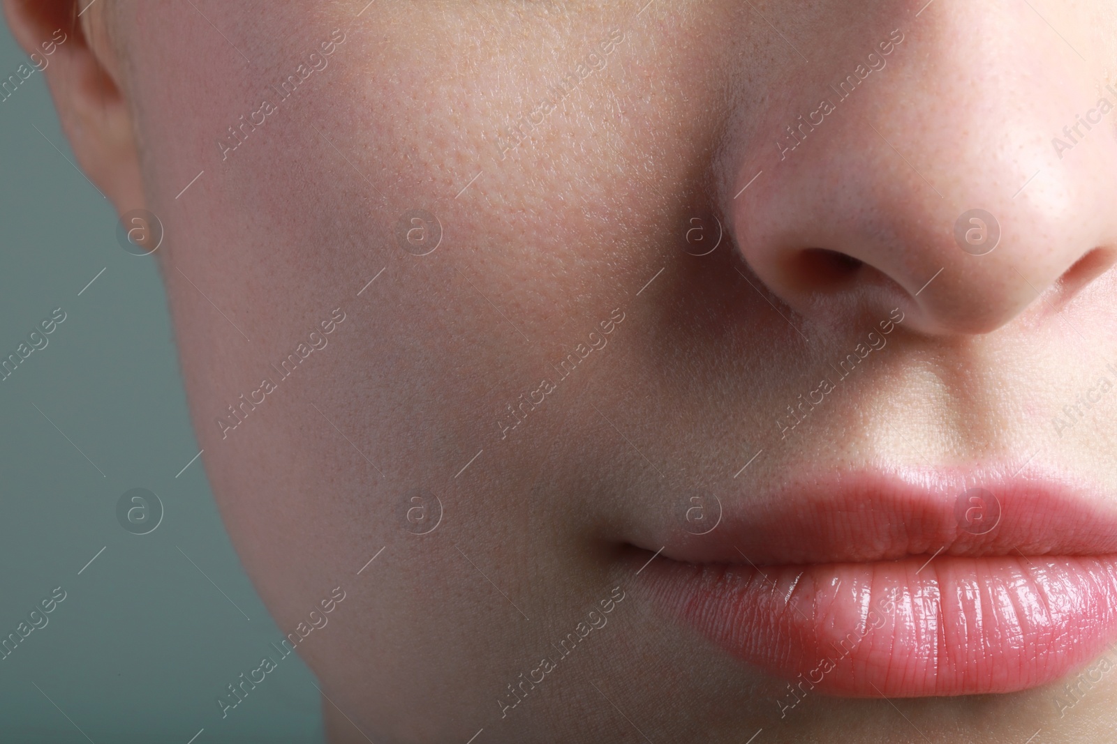 Photo of Closeup view of woman with healthy skin on light grey background