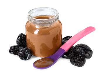 Jar with healthy baby food, dried prunes and spoon isolated on white