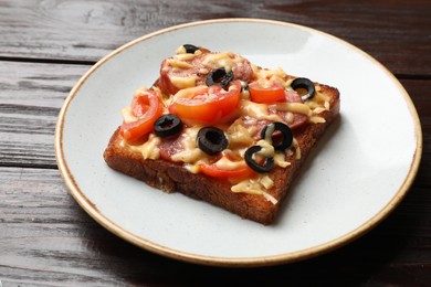 Tasty pizza toast in plate on wooden table