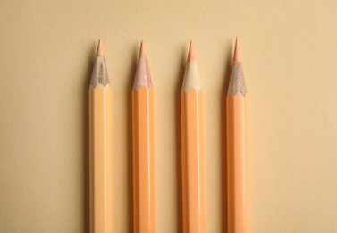 Photo of Flat lay composition with color pencils on beige background