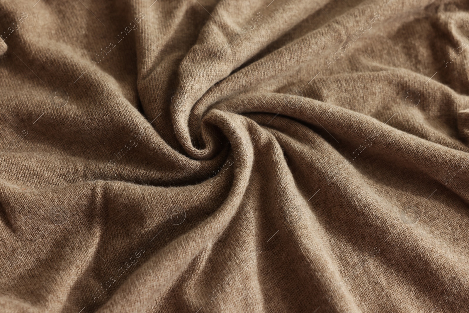 Photo of Beautiful light brown fabric as background, closeup