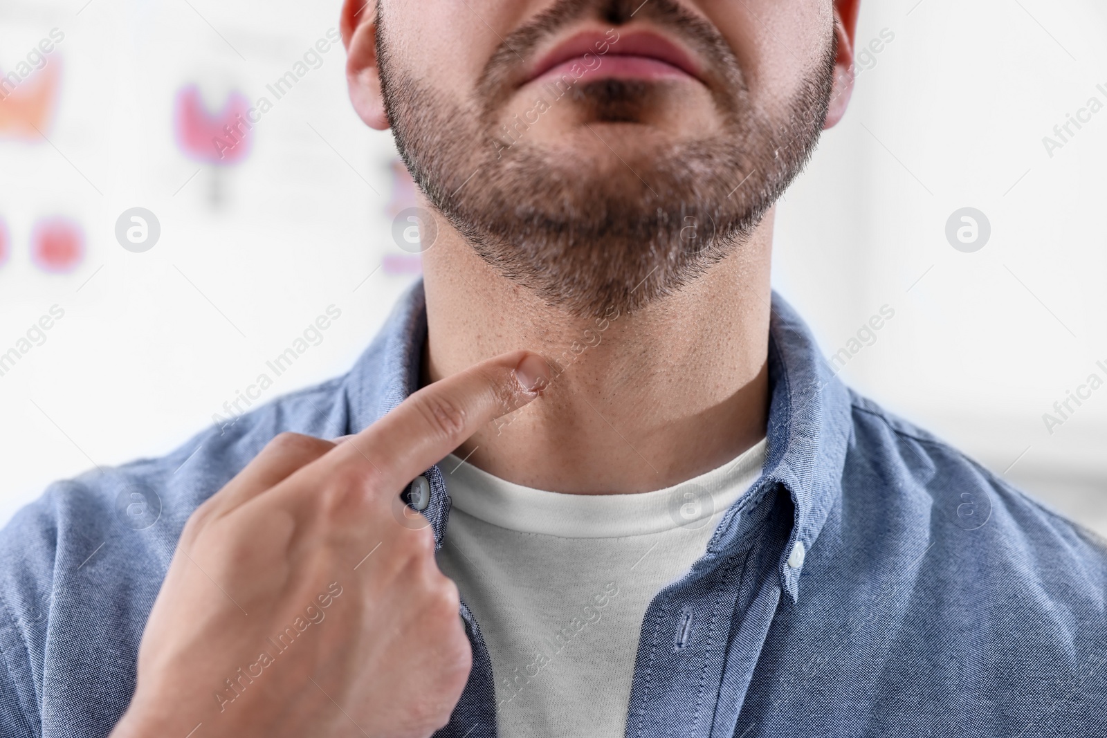 Photo of Endocrine system. Man doing thyroid self examination indoors, closeup