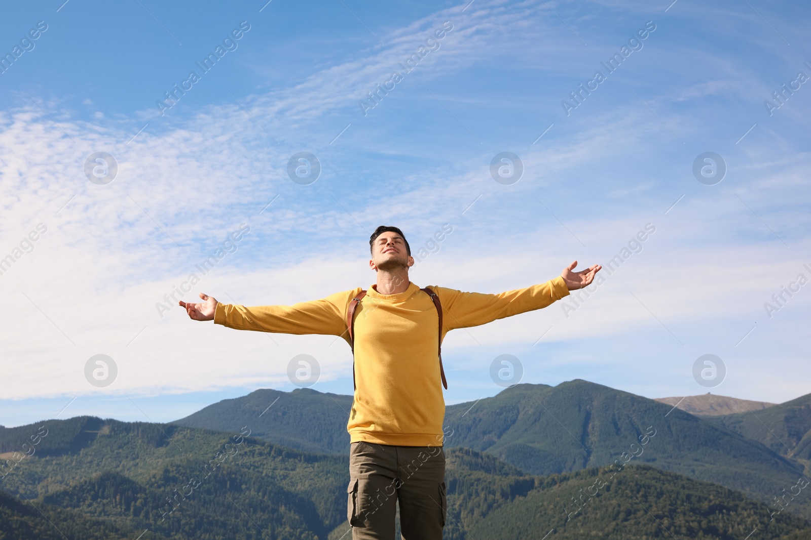 Photo of Happy tourist in mountains on sunny day