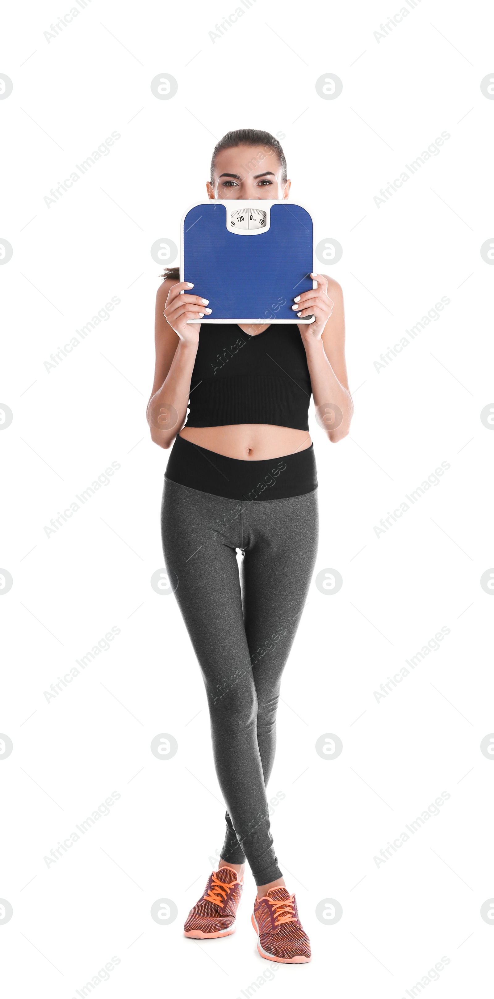 Photo of Happy young woman with scales on white background. Weight loss motivation