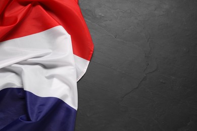 Photo of Flag of Netherlands on black background, top view. Space for text