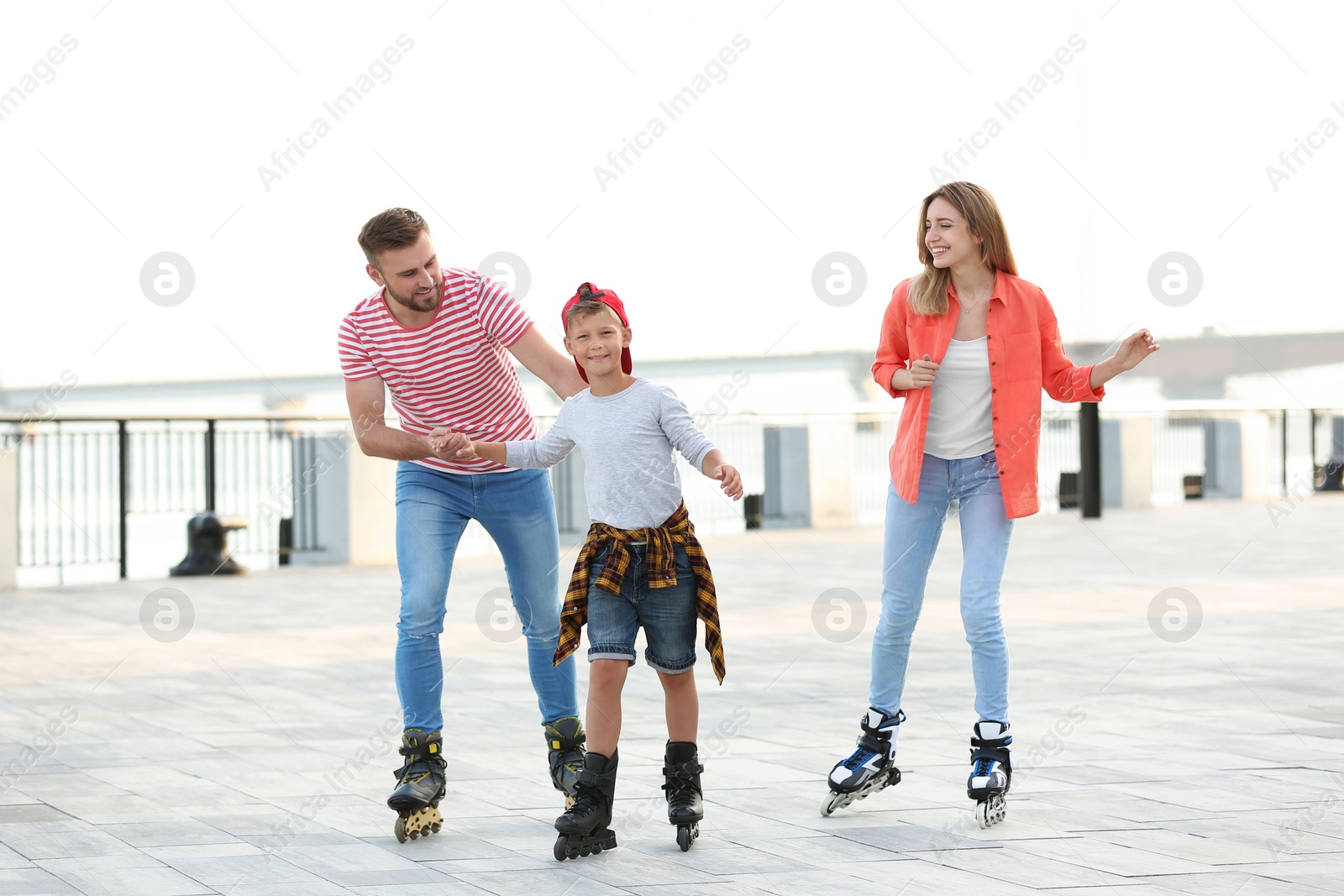 Photo of Happy family roller skating on city street