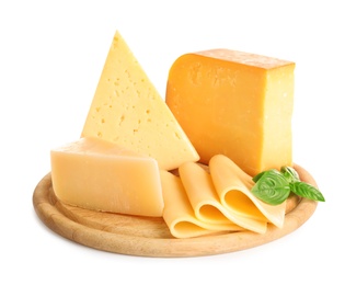 Wooden board with different kinds of cheese and basil on white background