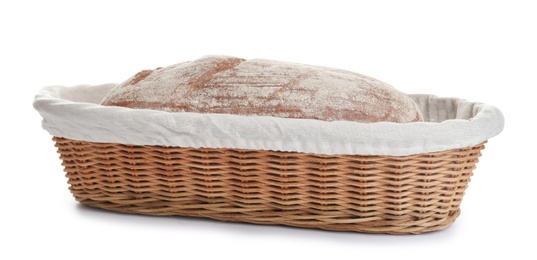 Loaf of tasty fresh bread in wicker basket on white background