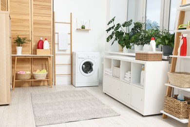 Laundry room interior with washing machine and furniture