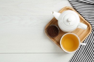 Buckwheat tea and granules on white wooden table, flat lay. Space for text