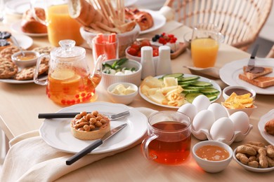 Photo of Dishes with different food on table indoors. Luxury brunch