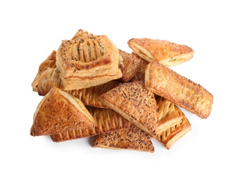 Heap of fresh tasty puff pastries on white background, top view