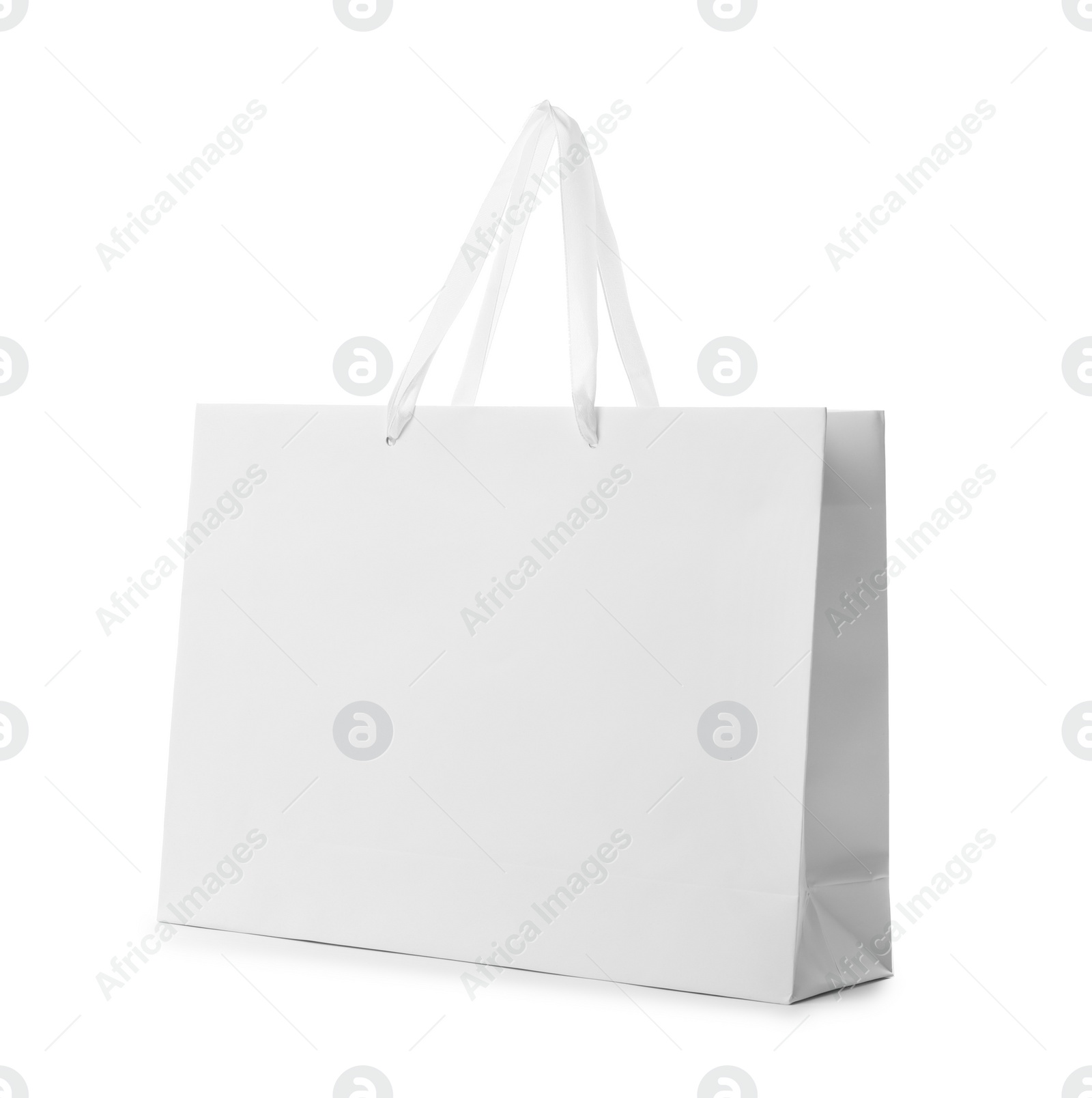 Photo of Paper shopping bag with handles on white background. Mockup for design