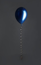 Photo of Color balloon with ribbon on dark background