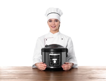 Photo of Female chef with modern multi cooker at table against white background