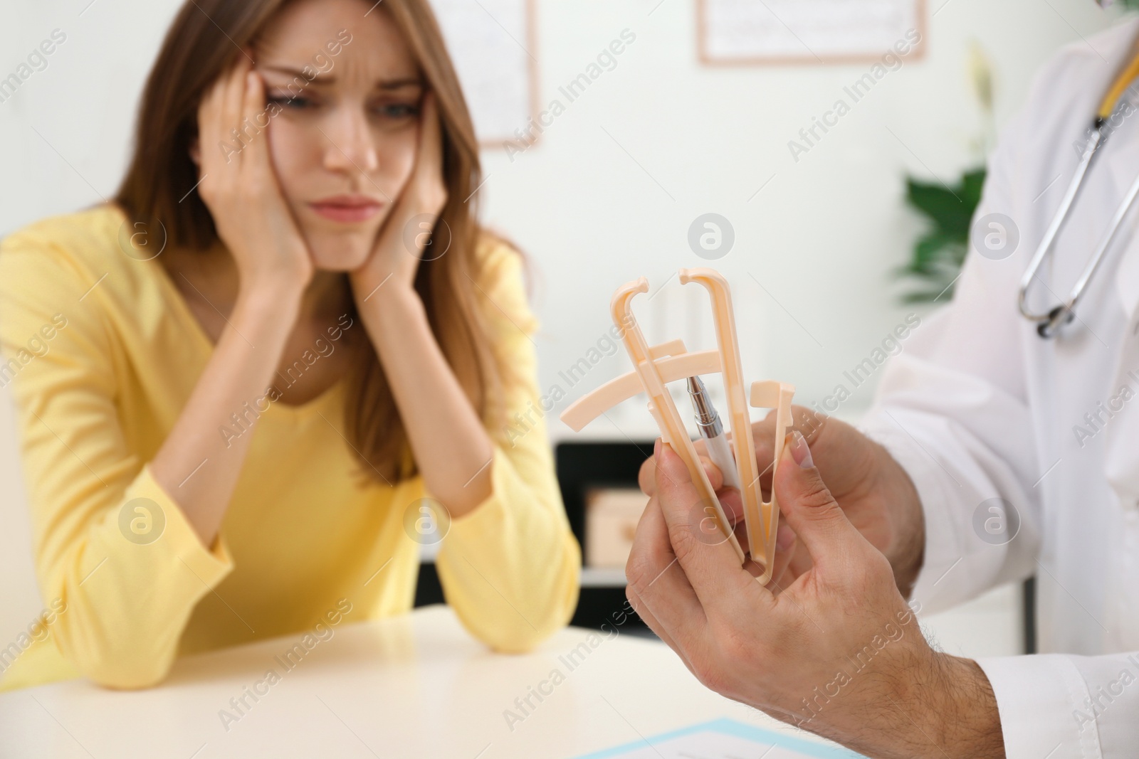 Photo of Nutritionist consulting patient in clinic, focus on hands