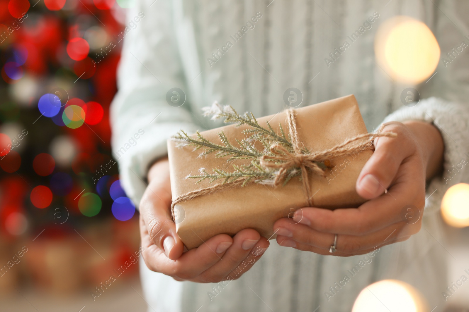 Photo of Woman holding Christmas gift box, closeup