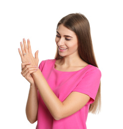 Photo of Happy young woman wearing beautiful engagement ring on white background