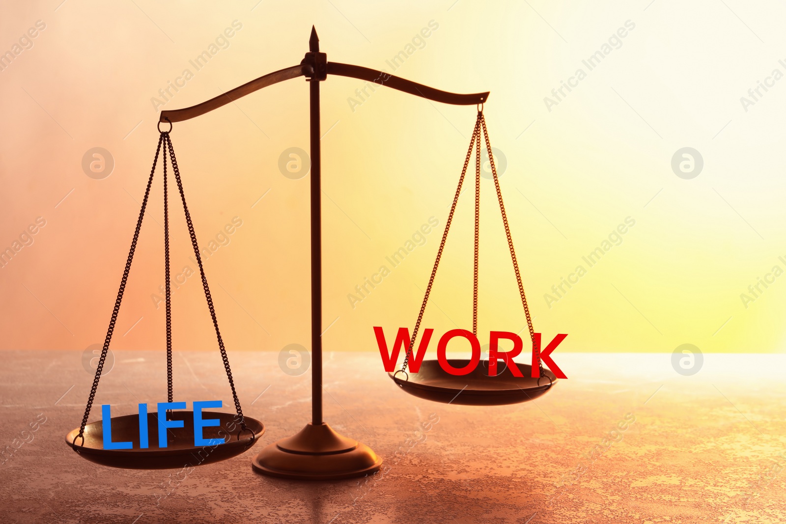 Image of Work-life balance concept. Scale with words on table