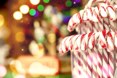 Candy canes on Christmas fair stall display, closeup. Space for text