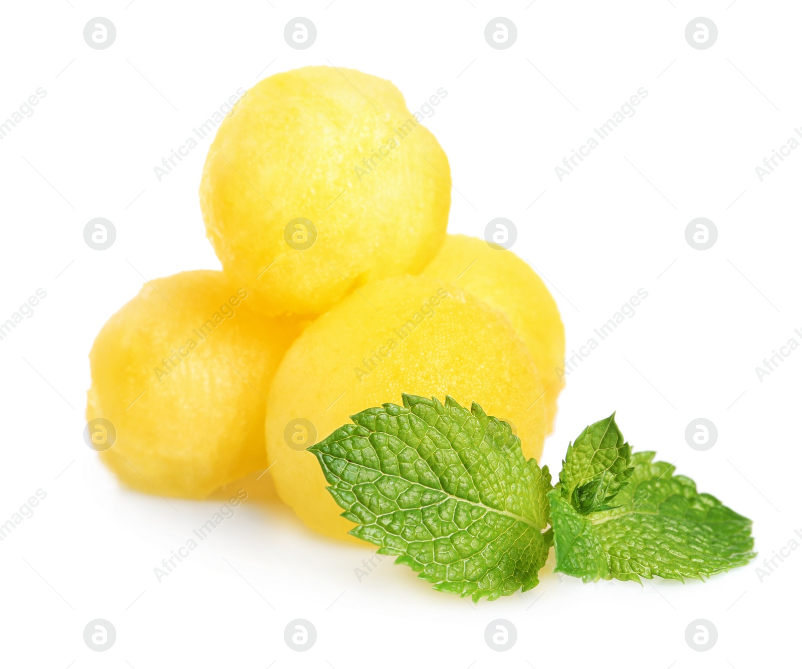 Photo of Juicy sweet melon balls with mint on white background