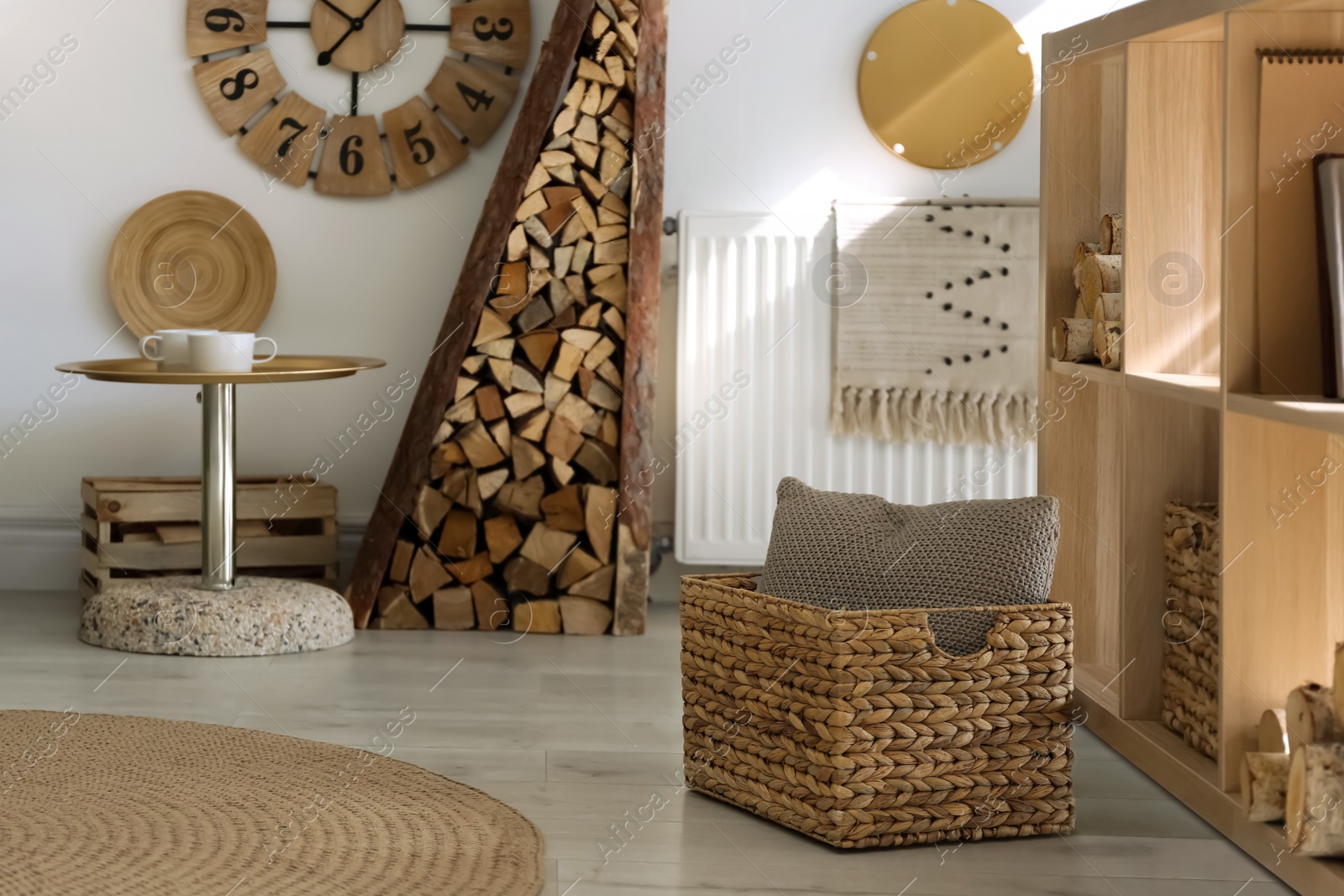 Photo of Stylish room interior with firewood as decorative element