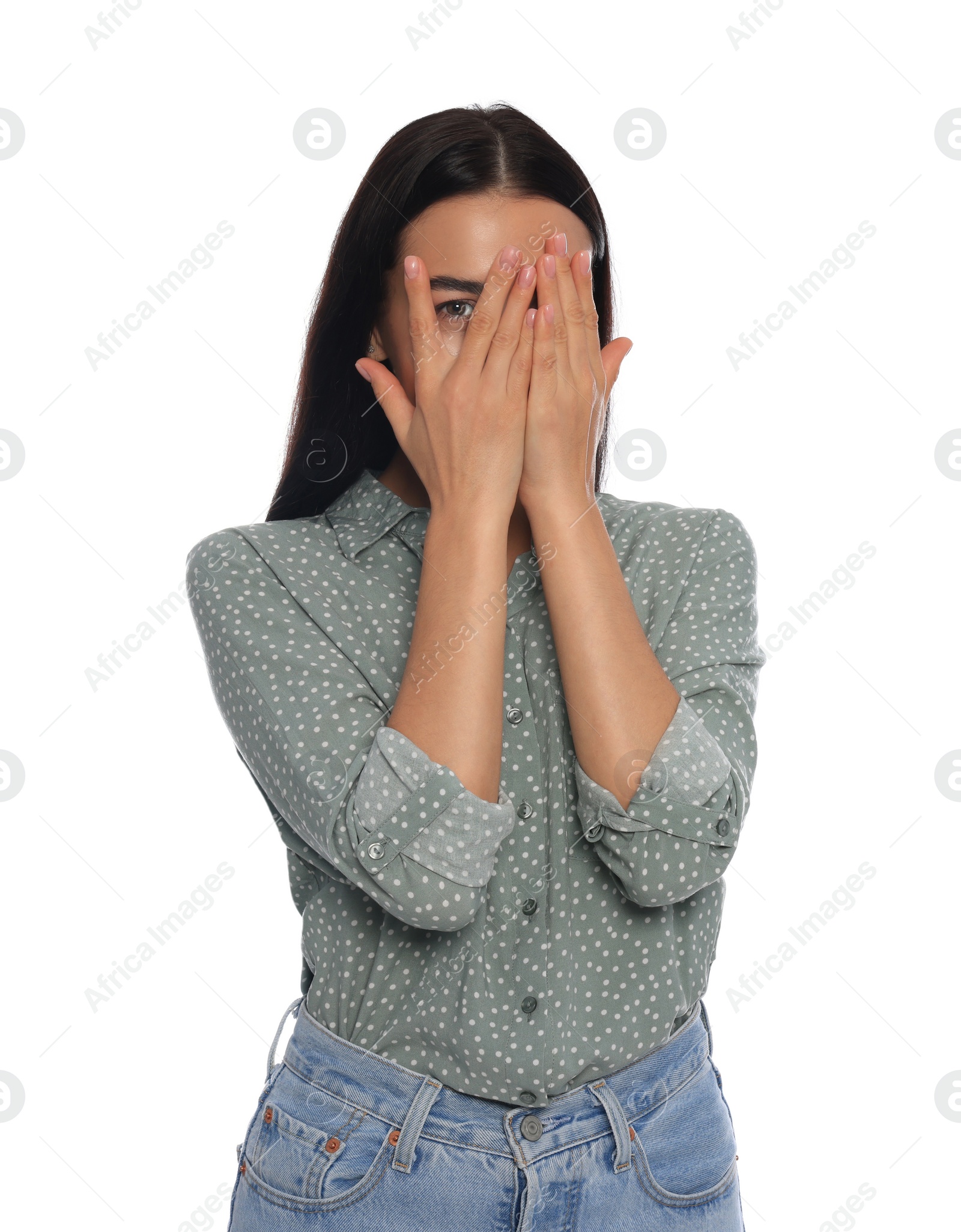 Photo of Embarrassed young woman covering face with hands on white background