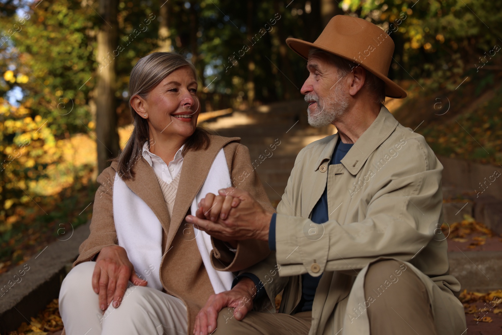 Photo of Affectionate senior couple spending time together in autumn park