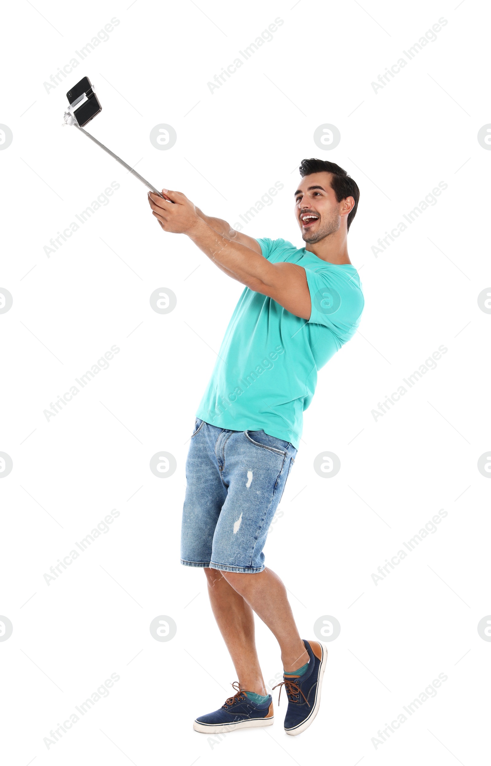 Photo of Happy young man taking selfie on white background